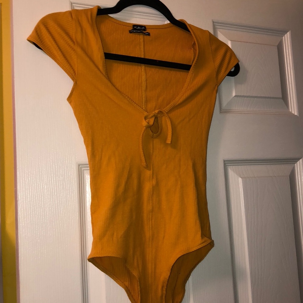 Out from under gold scoop neck bodysuit